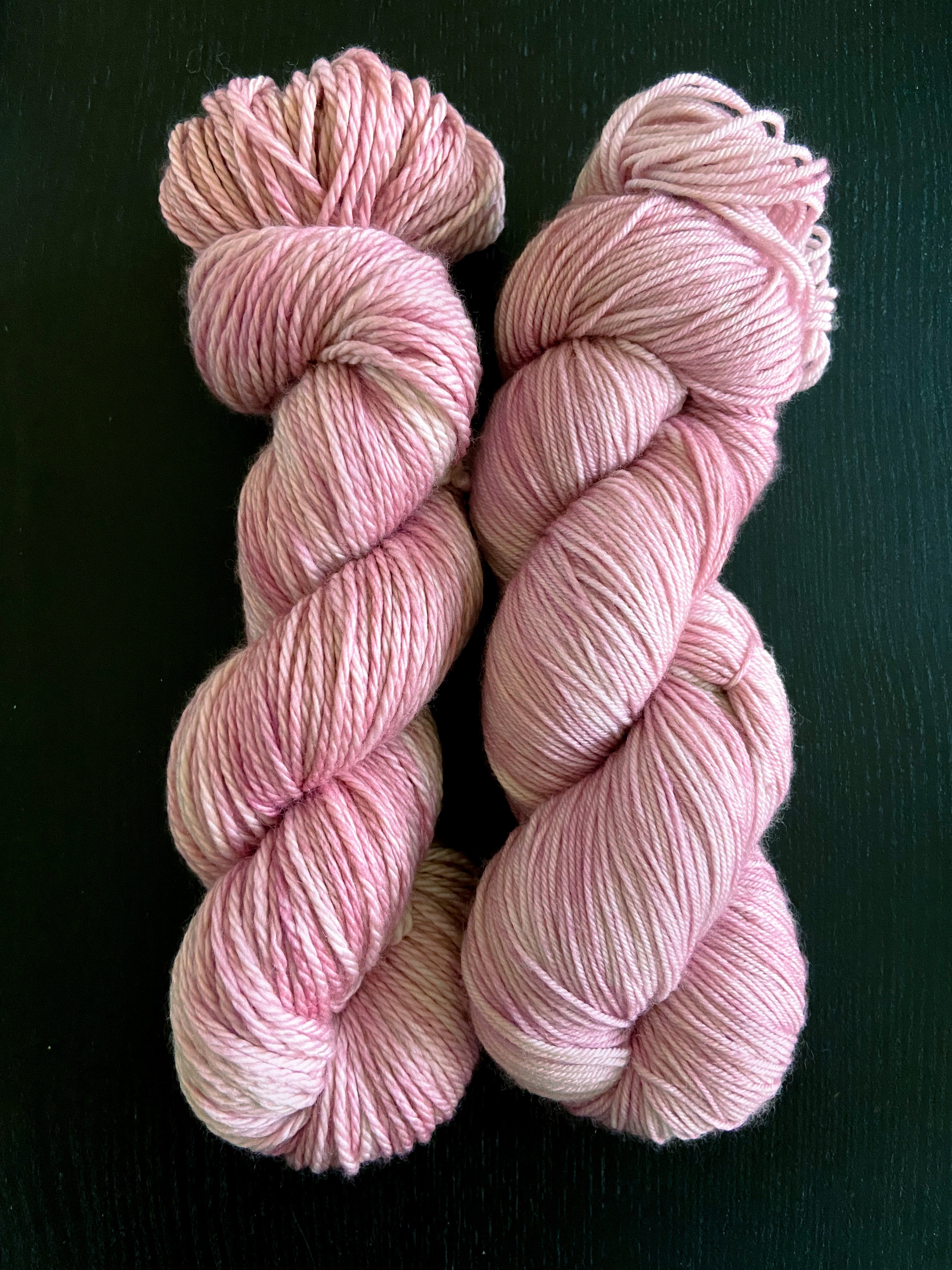 two skeins of hand dyed yarn laid side by side